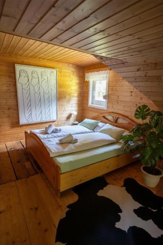 a bedroom with a large bed in a wooden room at Frein Chalets - Kaltenbach in Frein