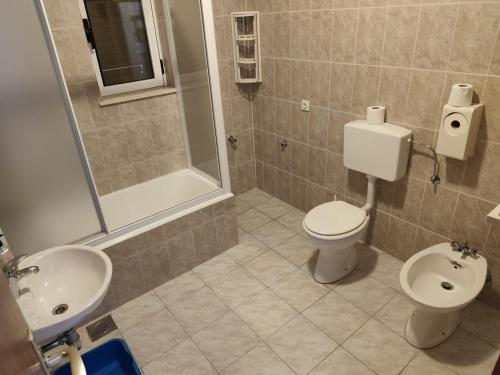 a bathroom with a toilet and a sink and a shower at Apartment Joso in Primošten