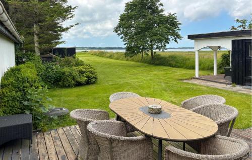 a wooden table and chairs on a deck at 3 Bedroom Pet Friendly Home In Roslev in Roslev