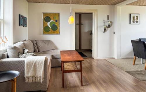a living room with a couch and a table at 3 Bedroom Pet Friendly Home In Roslev in Roslev