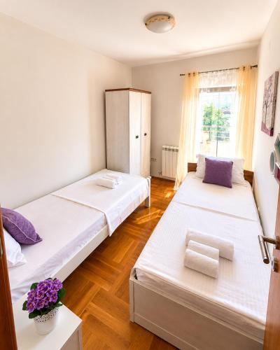 a bedroom with two beds and a window at Prizma in Cetinje