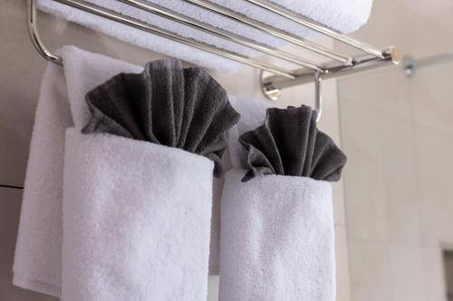 two towels hanging on a towel rack in a bathroom at Hotel Lunik in Prague