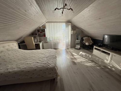 a bedroom with a bed and a television in it at Villa in Uman