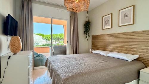 a bedroom with a large bed and a balcony at Puig Sa Guilla 1C B2 in Pals