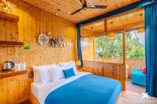 a bedroom with a bed in a wooden wall at Zostel Homes Mussoorie, Mall Road in Mussoorie