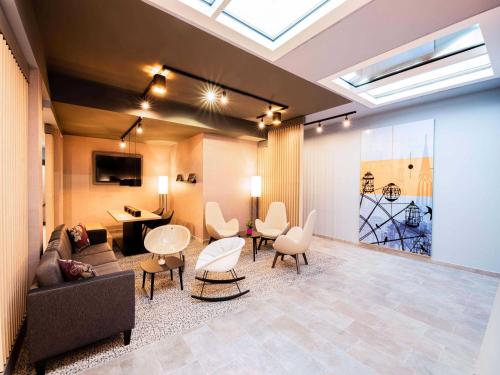 a living room with a couch and a table and chairs at B&B HOTEL Wien-Heiligenstadt in Vienna