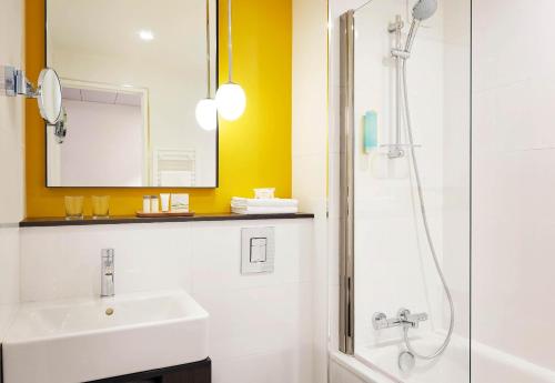 a bathroom with a sink and a shower at B&B HOTEL Paris 17 Batignolles in Paris