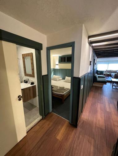 a living room with a room with a bed and a mirror at Mon Refuge 123 in Bcharré
