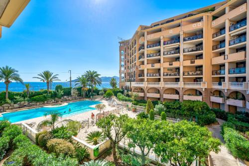 an aerial view of a hotel with a pool and a resort at Résidence La Palme d’Azur – Cannes in Cannes