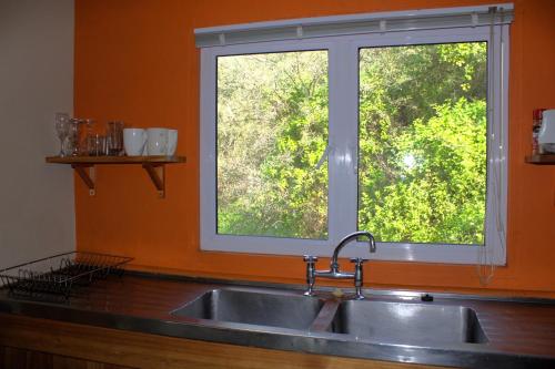 a kitchen with a sink and a window at Hangman's Lookout in Calitzdorp