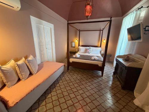 a bedroom with a bed and a mirror on the wall at Dimael Mansion in Fira