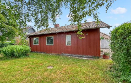 a red house with a yard in front of it at 2 Bedroom Pet Friendly Home In Haderslev in Haderslev