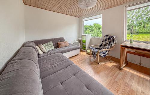 a living room with a large couch and a desk at 2 Bedroom Pet Friendly Home In Haderslev in Haderslev