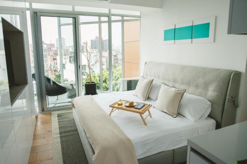 a living room with a couch and a table at Icon 701- Stylish Loft W AC Premium Location in Mexico City