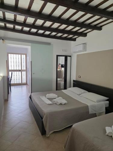a bedroom with two beds with towels on them at B&B Il Baglio in Locogrande