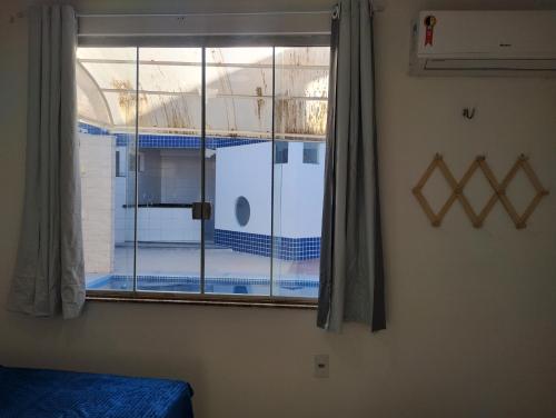 a bedroom with a window with a view of a boat at House Hotel Slz in São Luís