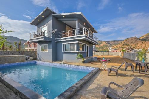 a villa with a swimming pool and a house at II EMPYREAN STAYS II LEONCINO VILLA II 4BHK II LARGEST SWIMMING POOL II AC Il in Lonavala