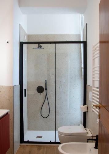 a bathroom with a shower with a toilet and a sink at MD Beach Home in Roseto degli Abruzzi