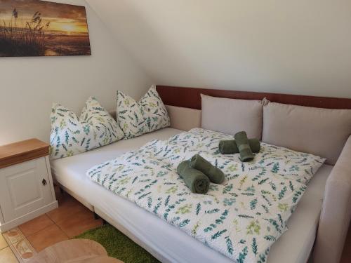 a bed with two teddy bears sitting on it at Salvia Guesthouse Balatonfüred in Balatonfüred