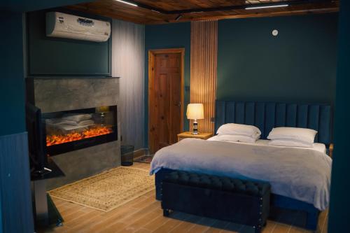 a bedroom with a bed and a fireplace at Valea Bhurban in Bhurban