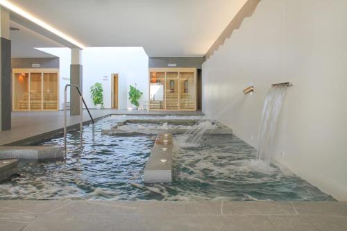 a pool of water in the middle of a room at Hotel & Spa Carlos desde 1996 in Melide
