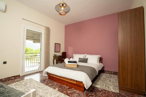 a bedroom with a bed with a purple wall at Karydeones Living in Kleidoniá