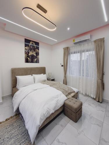 a bedroom with a large bed and a large window at Horizon Apartment at THE HIDDEN DOMUS I Pool View in Accra