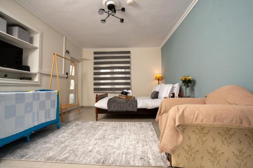 a bedroom with a bed and a couch at Karydeones Living in Kleidoniá