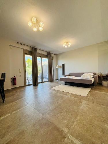 a large living room with a bed and sliding glass doors at Danita Apartments 3 in Paleros