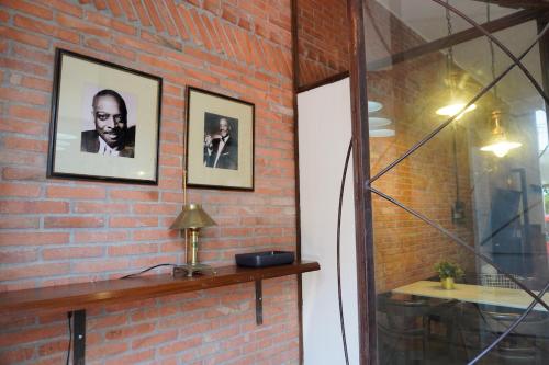 a brick wall with two pictures of a man on it at Loft Pedreña Studio in Pedreña