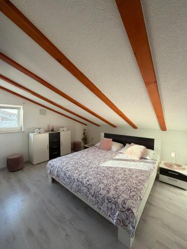 a bedroom with a large bed in a attic at Guesthouse Casa Barbaro in Rovinjsko Selo