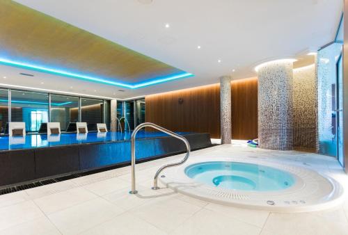 a bathroom with a jacuzzi tub in a building at Hotel Olympic Spa & Wellness in Ustroń