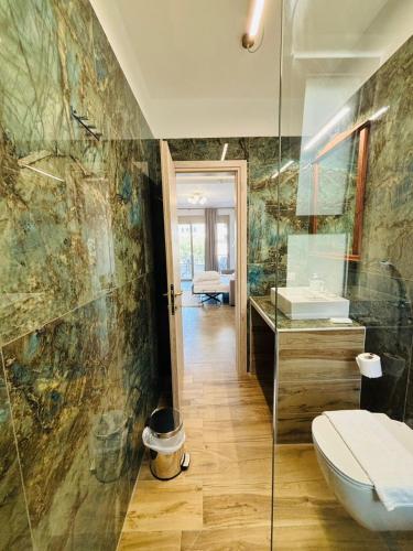 a bathroom with a toilet and a sink and a mirror at Danita Apartments 3 in Paleros