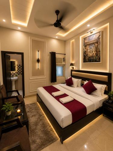 a bedroom with a large bed with red pillows at Hotel Gopal in Haridwār