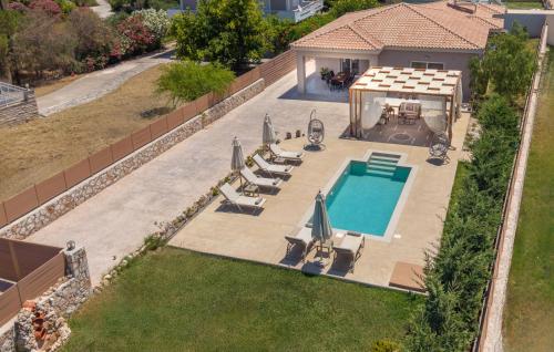an overhead view of a swimming pool with chairs and a house at Villa Nicoldia with private pool near Laganas in Laganas