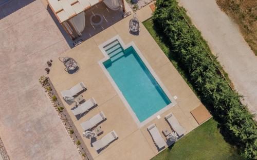 an overhead view of a swimming pool with lounge chairs at Villa Nicoldia with private pool near Laganas in Laganas