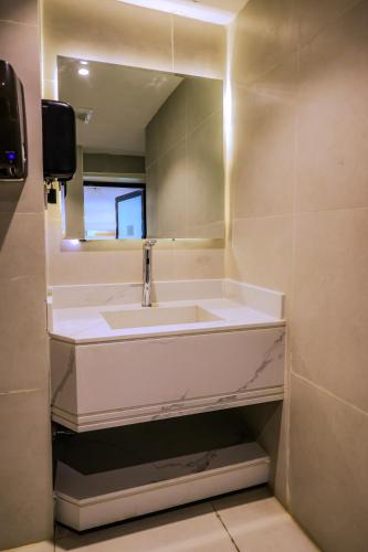 a bathroom with a white sink and a mirror at Nawara Takhasossi - Economic in Riyadh