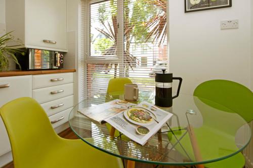 a glass table in a kitchen with a plate of food on it at Autumn Heights Apartments in Telford