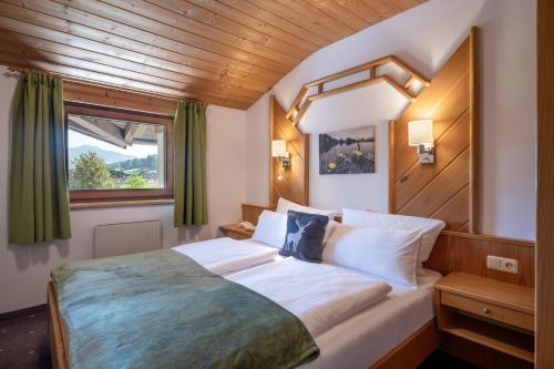 a bedroom with a large bed with a window at Apartment Anita in Westendorf