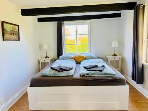 a bedroom with a large bed with a window at Haus Sommerlycka in Fågelfors