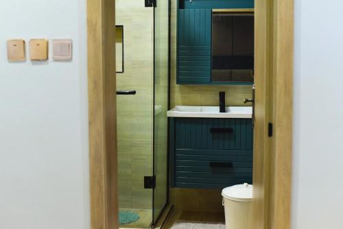 a bathroom with a sink and a glass shower at One Bedroom, Double bed and one sofa bed in Iseri