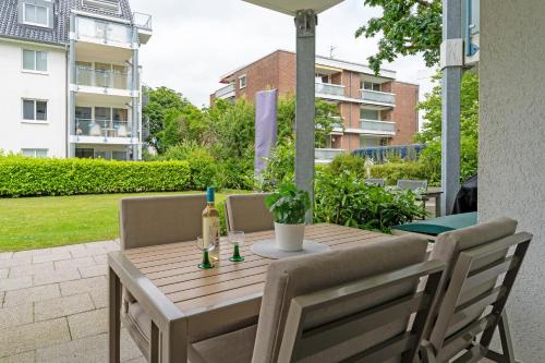 a wooden table with two bottles of wine on a patio at Baltic Studio No 5 in Scharbeutz