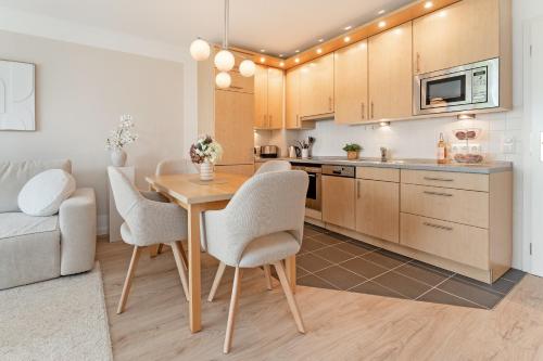 a kitchen with a table and chairs in a room at Baltic Studio No 5 in Scharbeutz
