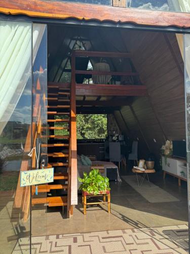 a room with a staircase in a tent at Chalé Paraíso in Nerópolis
