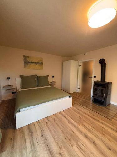 a bedroom with a large bed and a fireplace at Ruheoase am Stadtrand in Buchholz in der Nordheide
