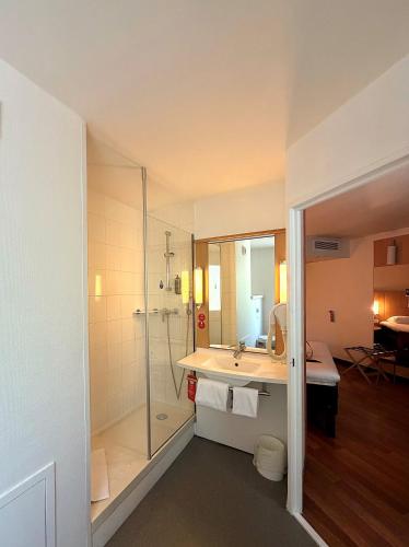 a bathroom with a shower and a sink at Ibis Angers Centre Château in Angers