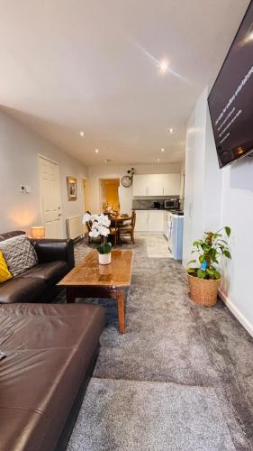 a living room with a couch and a table at Sleeps 5 Free Parking Fast WiFi Near Hillsborough Easy Access to Sheffield City Centre and Peak District in Hillsborough