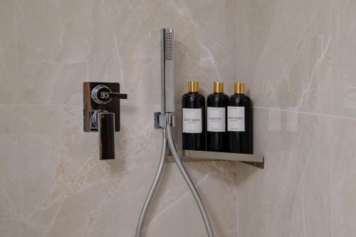 three bottles of wine on a shelf in a bathroom at Rodia Luxury Villa in Plakias