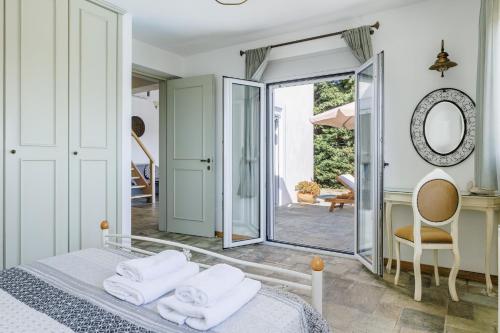 a bedroom with a bed and a mirror at Villa Calma in Patitiri