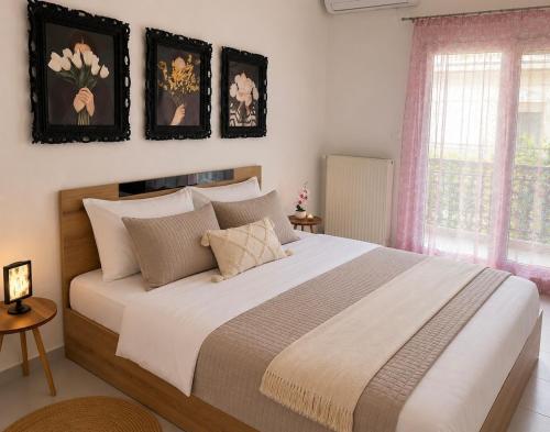 a bedroom with a large bed with pillows at Stavros Green & Sea Holiday Home in Stavros